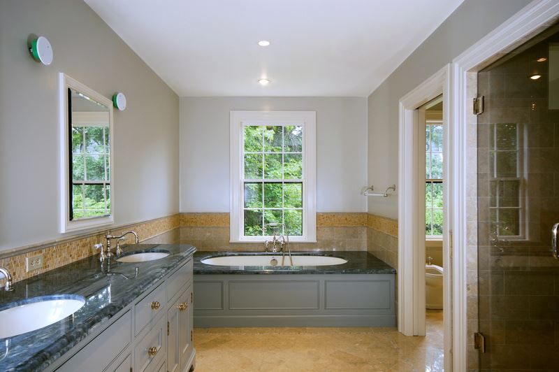 Remodeled bathroom with double sinks and large tub