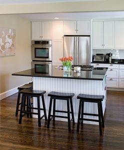 Remodeled kitchen island with stools around it