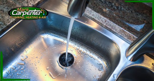 Close up of kitchen sink with water running
