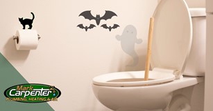 Clogged toilet surrounded by spooky Halloween graphics.