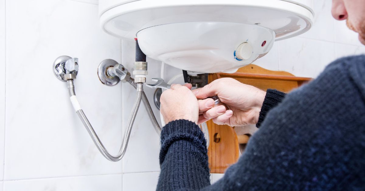 man working on plumbing