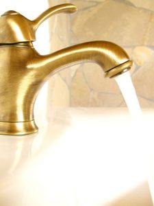 Gold faucet with water coming out