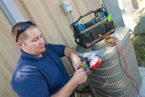 HVAC technician doing maintenance