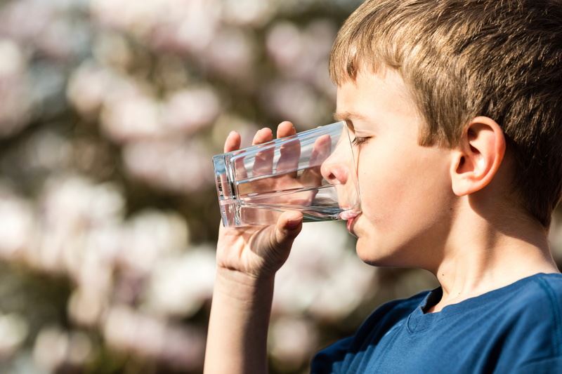 Boy drinking a glass of water