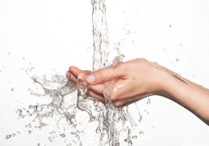 Hands under a running stream of water